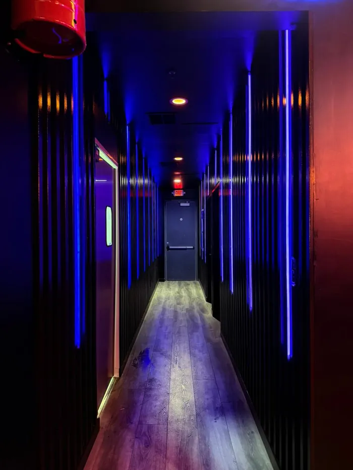 Corridor lined with vertical blue neon tubes