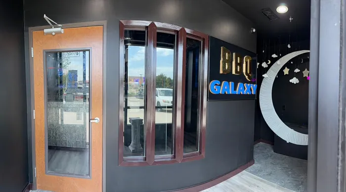 Front lobby with the gold and blue BBQ Galaxy sign and crescent moon seat